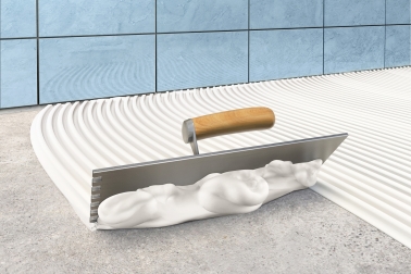 Illustration of trowel applying SikaCeram Easy tile adhesive
