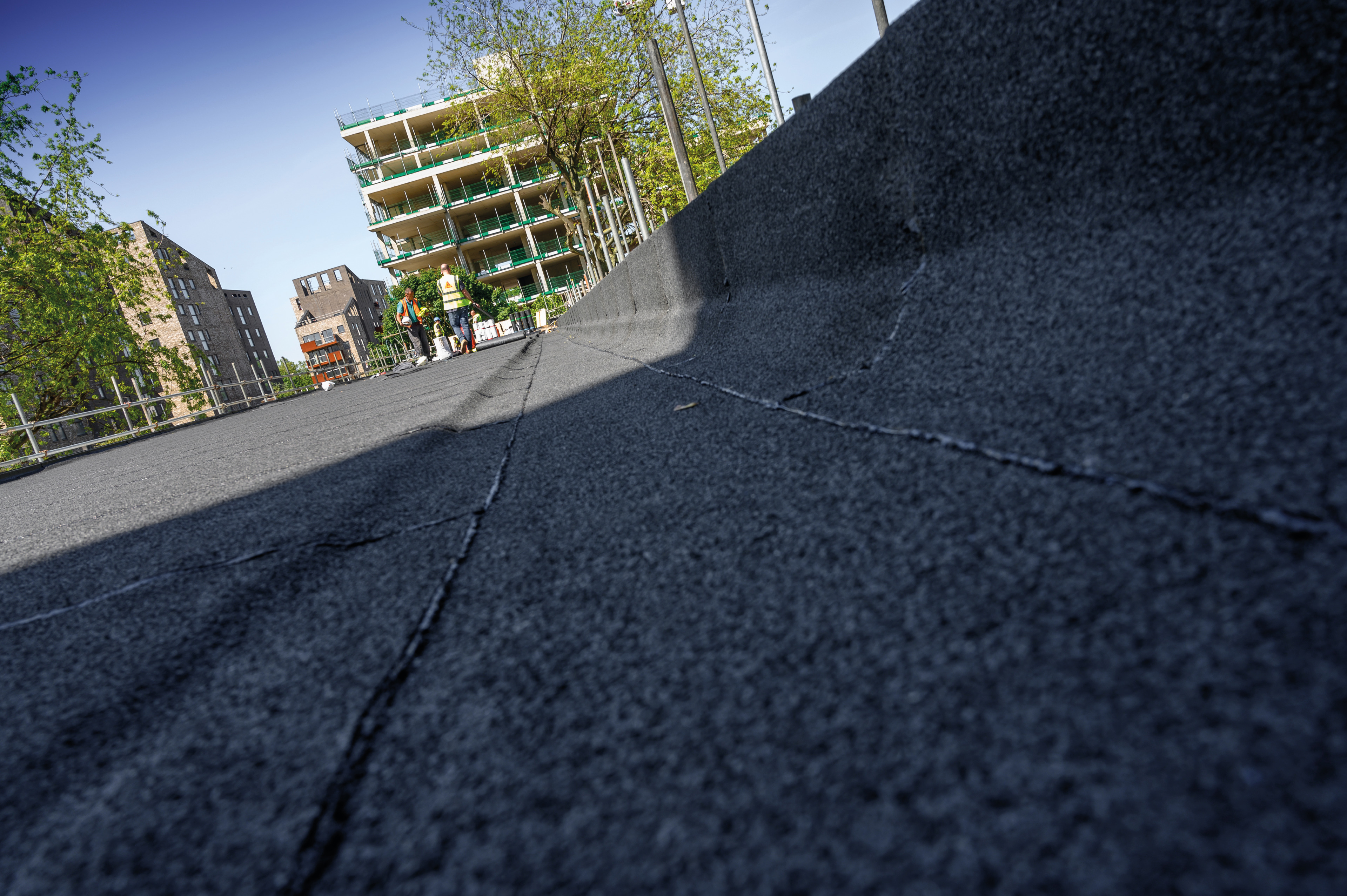 Close up view of bitumen membrane applied on roof at parapet
